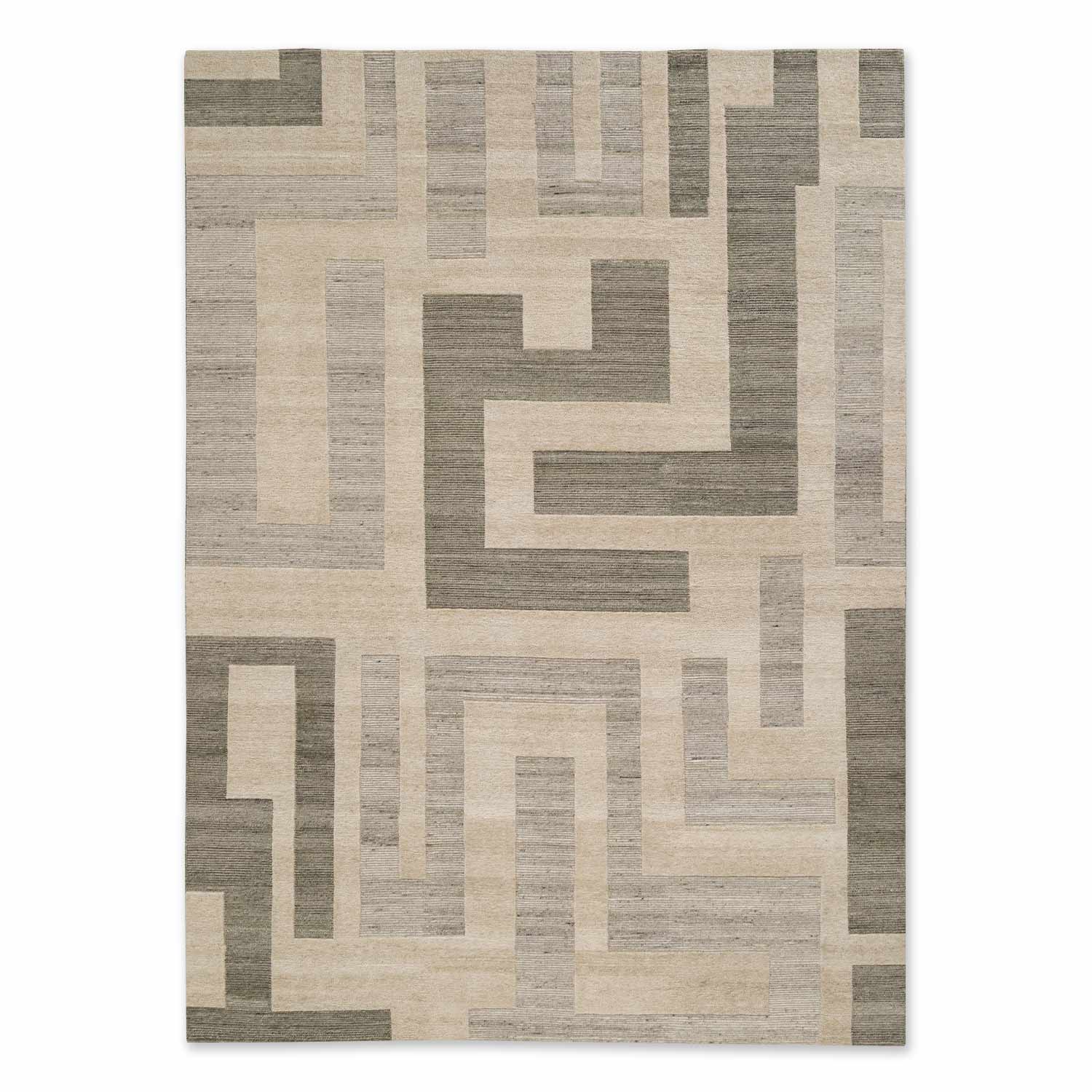 A contemporary hand knotted woollen rug with a geometric pattern in dark and light hues.